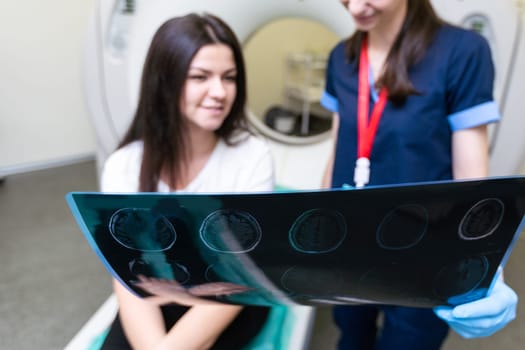 Young doctor looking at computed tomography x-ray image.