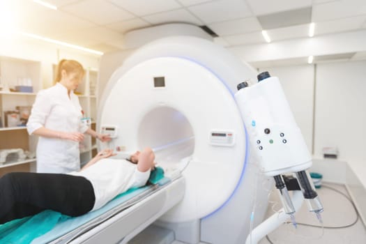 Female patient undergoing MRI - Magnetic resonance imaging in Hospital. Medical Equipment and Health Care.