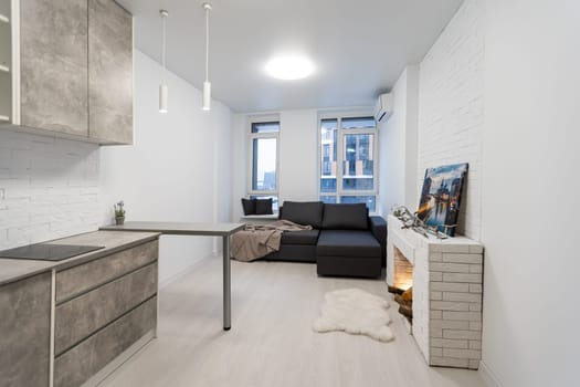 Modern studio flat with small kitchen, sofa