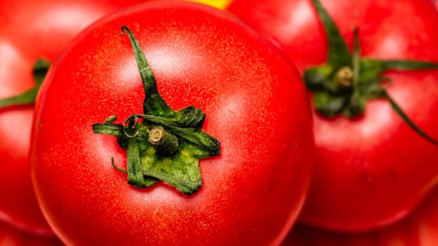 Close up of ripe red tomato, tomatoes background.