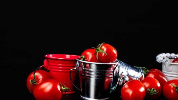 Selective focus on composition with mini decorative bucket and tomatoes. Small metal bucket with cherry tomatoes