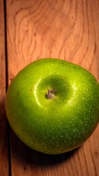 Tasty organic green juicy green apples on a rustic wooden background