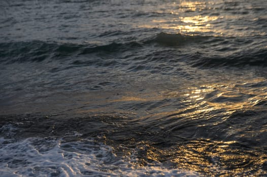 Bright sunset over the Mediterranean Sea Cyprus golden clouds reflected in the water