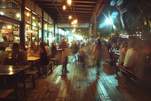 A blurry image of a busy city street with people walking and sitting at tables outside of restaurants. Scene is lively and bustling, with the blurred effect giving a sense of motion and energy