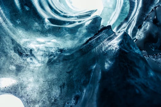 Massive ice blocks inside crevasse, vatnajokull glacier with transparent cracked texture in iceland. Iceberg rocks slowly melting in ice caves, covered frost texture in nordic landscape.