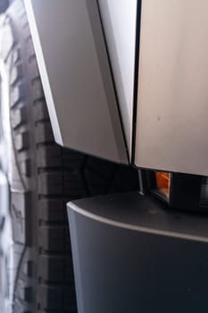Denver, Colorado, USA-May 5, 2024-This image showcases the seamless design and sturdy architecture of the Tesla Cybertruck, featuring a detailed view of the side panel and tire, emphasizing the vehicle unique and innovative structure.
