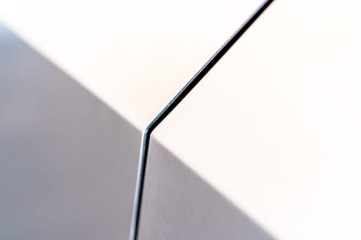 Denver, Colorado, USA-May 5, 2024-A close-up image capturing the precise panel seam of the Tesla Cybertruck, highlighting the minimalist design and sharp contours that characterize the exterior of this innovative electric vehicle.