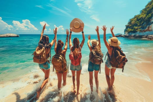 A group of five women are standing on a beach, one of them holding a hat. They are all smiling and seem to be enjoying their time together