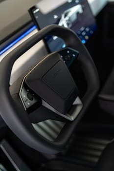 Denver, Colorado, USA-May 5, 2024-This image captures the futuristic interior of the Tesla Cybertruck, focusing on the steering wheel and its integrated control panels, highlighting the vehicle advanced technology.