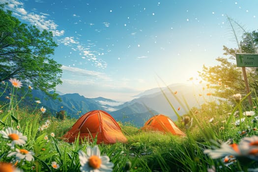 Two orange tents are set up in a grassy field with a beautiful view of the mountains. The scene is peaceful and serene, with the sun shining brightly