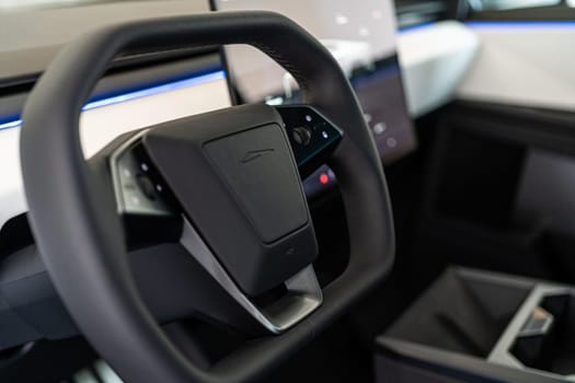 Denver, Colorado, USA-May 5, 2024-This image captures the futuristic interior of the Tesla Cybertruck, focusing on the steering wheel and its integrated control panels, highlighting the vehicle advanced technology.