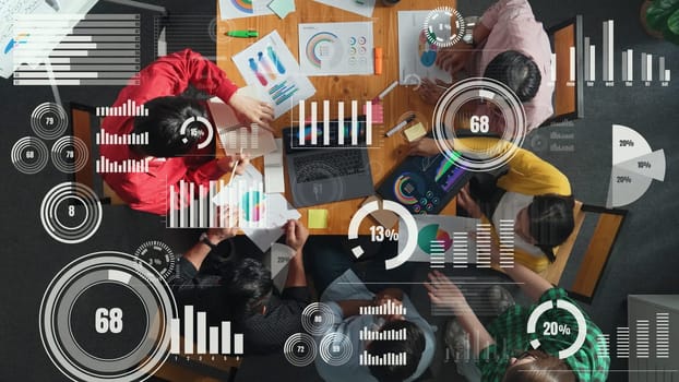 Top view of business people working financial graph with global networking. Smart manager working together while looking at tablet display statistic with hologram of communication system. Convocation.