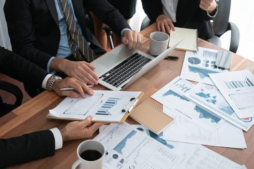 Diverse group of business analyst team analyzing financial data report paper on office table. Chart and graph dashboard by business intelligence analysis for strategic marketing planning Habiliment