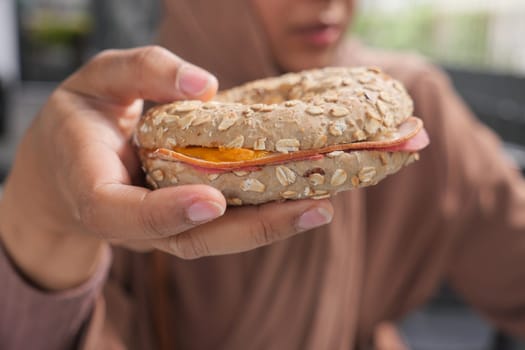 women hand holding beef burger .