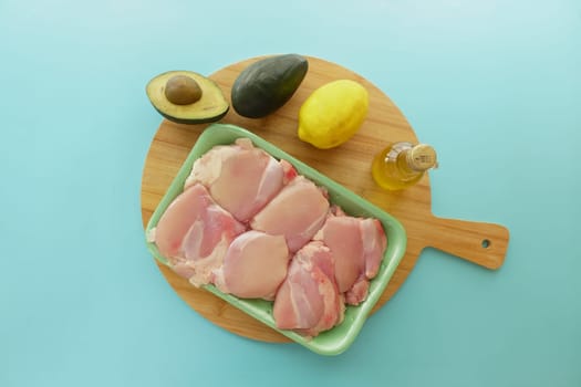 raw breast chicken meat on a chopping board .