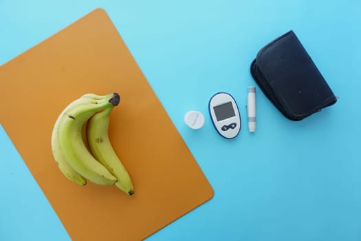 Close up of diabetic measurement tools and pills on pink background .