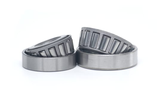 Single row tapered roller bearings isolated on white background. Spare parts for machinery and automotive industry