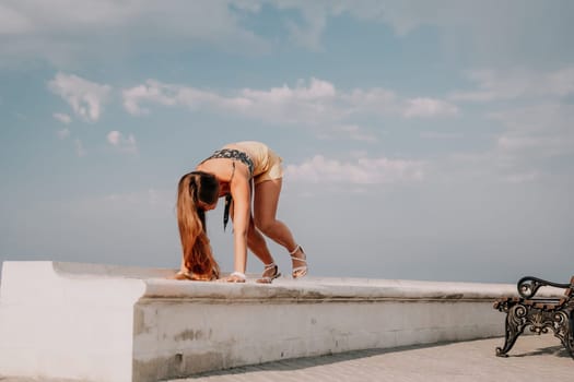 Woman park yoga. Side view of free calm bliss satisfied woman with long hair standing in morning park with yoga position against of sky by the sea. Healthy lifestyle outdoors in park, fitness concept