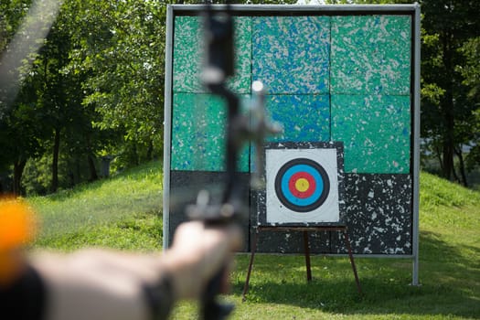 Archer holds his bow aiming at a target. selective focus