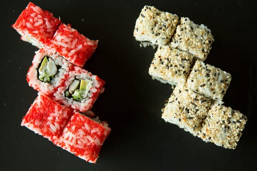 Sushi set over black background. Close up