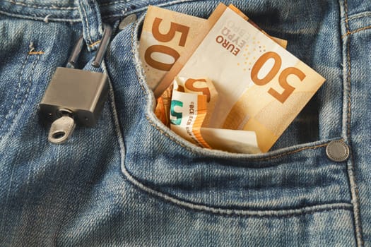 jeans with euro banknotes coming out of the pocket with a padlock