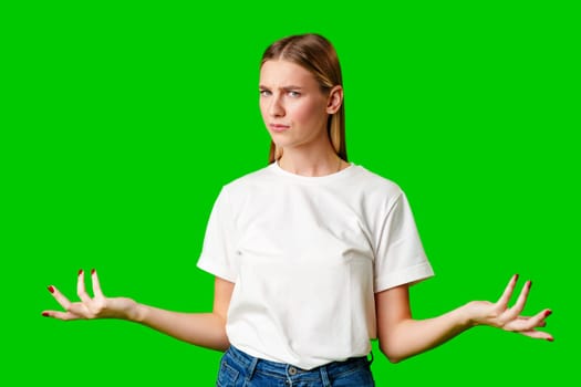 Young Woman Holding Out Hands against green background in studio