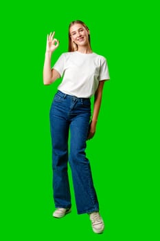 Young Woman Giving Thumbs Up Sign on Green Screen in studio