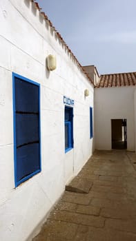 Asinara, Italy. August 11, 2021. A glimpse of the courtyard and the kitchen door of the prison museum on the hill of the island.