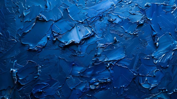 A close up of a vibrant electric blue painting on a wall, resembling the fluidity of water. The pattern is reminiscent of ocean waves freezing into an ice cap, with transparent materials adding depth