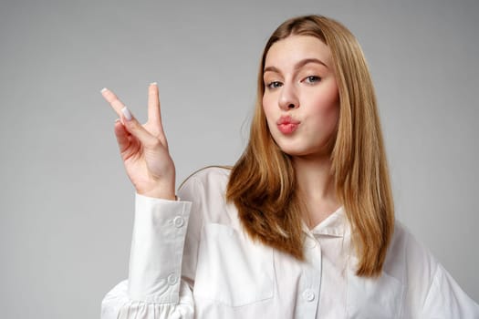 Young Woman Making Peace Sign With Fingers