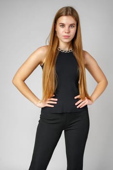 Young Woman With Long Hair in Black Pants and Top