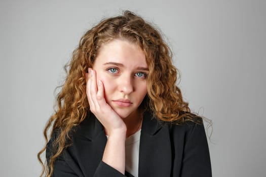 Young Woman With Curly Hair Expressing Concern Upset Sad