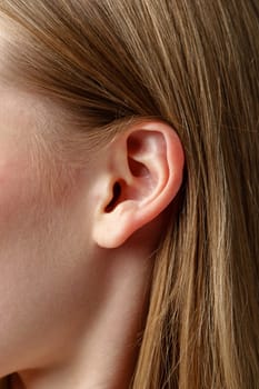 Close Up photo of Young Blonde Womans Ear