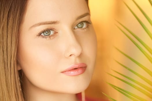 Summer beauty, makeup and skincare, face portrait of beautiful woman with tropical palm tree leaf, natural makeup for cosmetics and fashion look idea