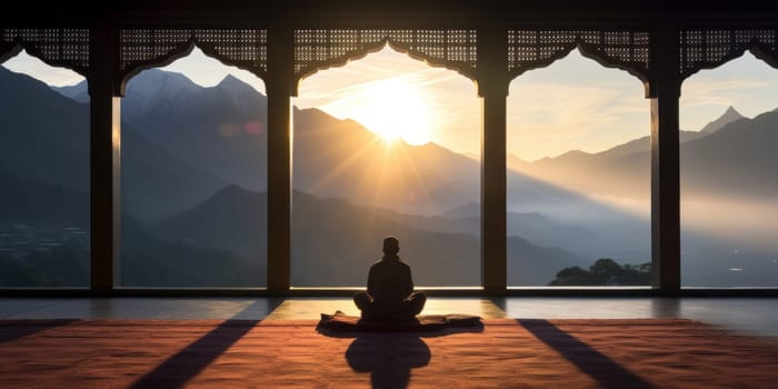 Man meditating on mosque terrace during sunset