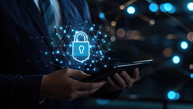 Business professional using tablet with glowing padlock hologram symbolizing cybersecurity