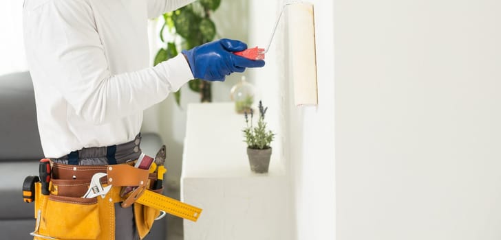 Male with belt full of hand instruments for repairing home