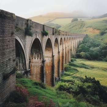 Peaceful viaduct bridge surrounded by lush green hills and countryside