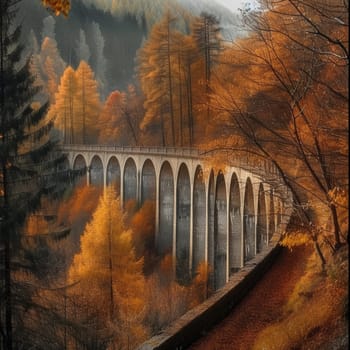 Old viaduct bridge enveloped in fog with autumn colors in the surrounding forest