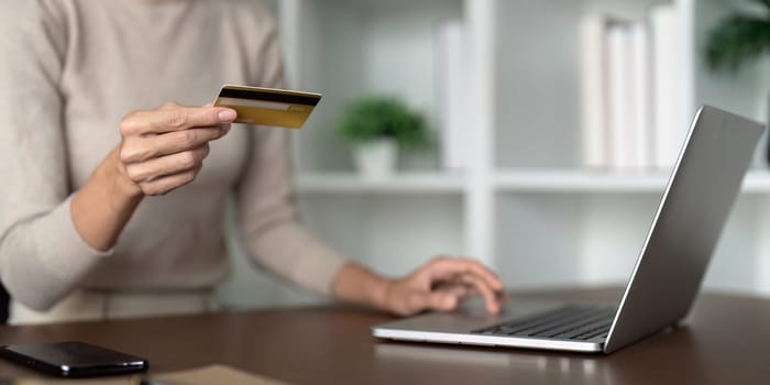 Woman use credit card on laptop and online shopping, payment and ecommerce at home, bank app and sale on store website with internet banking.