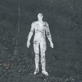 A detailed chalk outline of a human figure on a weathered asphalt street