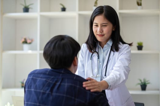 Female doctor gives advice to young patient who is stressed and has health and medical problems in clinic.