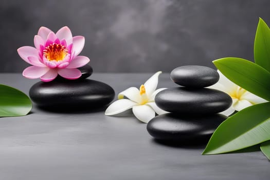 Spa gray background with massage stones, exotic flowers and copy space