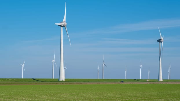 A serene field of vibrant green grass stretches out before us, dotted with a collection of majestic windmills spinning gracefully in the background.