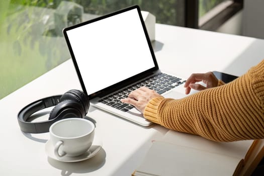 Young female with laptop at home on white blank screen for montage mockup display device in concept of lifestyle work at home with digital technology.