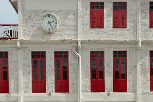 Bangkok, Thailand - 12 Jun, 2023 - Architecture exterior view of Chinese style building with Round white watch face. Concept and design front of Chinese retro style, Space for text, Selective focus.