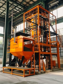 Orange industrial machinery in a factory setting, symbolizing manufacturing power