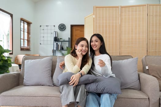 gay couple hug on sofa to relax together in healthy relationship love connection. Lgbtq couple concept.