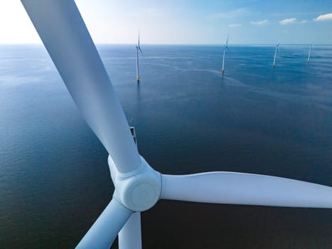 A single wind turbine stands tall in the middle of the vast ocean, harnessing the power of the wind to generate renewable energy. close up of windmill turbine at sea in the Netherlands