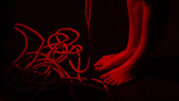 Close-up of woman's feet and ropes. Japanese shibari technique